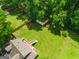 Aerial view showing the backyard with lush lawn, a deck with stairs, and a detached garage at 3777 Edward Rd, Rex, GA 30273
