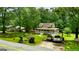 Scenic aerial view showcasing a charming home, verdant lawns, and mature trees in a tranquil setting at 3777 Edward Rd, Rex, GA 30273