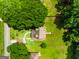 Aerial view showcasing property with mature trees, a home with a deck, and a well-manicured lawn at 3777 Edward Rd, Rex, GA 30273