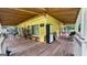Spacious covered deck featuring ample seating, a large minifridge, and an open wood beam ceiling at 3777 Edward Rd, Rex, GA 30273