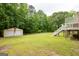 Backyard shows a detached two-car garage and stairs leading to the back deck at 3777 Edward Rd, Rex, GA 30273