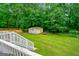 Expansive backyard featuring a two-car garage and lush greenery, ideal for outdoor activities at 3777 Edward Rd, Rex, GA 30273