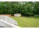View of backyard showing a two-car garage and expansive lawn at 3777 Edward Rd, Rex, GA 30273