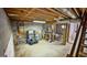 Unfinished basement, showing exposed beams, concrete walls and floor, and some plumbing work at 3777 Edward Rd, Rex, GA 30273
