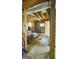 Unfinished basement with exposed beams, concrete floor, and two small windows at 3777 Edward Rd, Rex, GA 30273