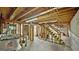 Unfinished basement featuring exposed beams, concrete walls, a ladder, and bike storage at 3777 Edward Rd, Rex, GA 30273