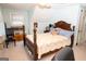 Light blue bedroom with a wooden bed frame and natural light at 3777 Edward Rd, Rex, GA 30273