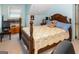 Bedroom with a wood bed frame and floral quilt, complemented by a wooden chest and a side chair at 3777 Edward Rd, Rex, GA 30273