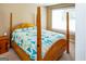 Bedroom with a four post bed and a blue and white quilt and a window providing natural light at 3777 Edward Rd, Rex, GA 30273