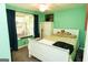 This bedroom features mint-colored walls, a white bed frame, and bright window at 3777 Edward Rd, Rex, GA 30273