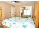 Bedroom features a bed with a vibrant blue and yellow geometric-patterned quilt and mirrored closet at 3777 Edward Rd, Rex, GA 30273