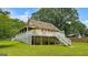 Back exterior of a two-story home featuring a large yard and a covered porch with two separate staircases at 3777 Edward Rd, Rex, GA 30273