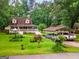 Aerial view showcasing the home, carport, manicured lawns, mature trees and surrounding neighborhood at 3777 Edward Rd, Rex, GA 30273