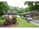 Home with carport, beautiful rose bushes, lush lawn, and American flag displayed at 3777 Edward Rd, Rex, GA 30273