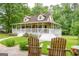 View of the front of the property with covered porch and inviting outdoor chairs at 3777 Edward Rd, Rex, GA 30273