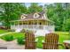 Charming two-story home featuring a welcoming front porch with white railings and inviting wooden chairs at 3777 Edward Rd, Rex, GA 30273