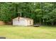 Detached two-car garage in backyard with adjacent grassy yard at 3777 Edward Rd, Rex, GA 30273