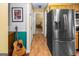 Hallway featuring a stainless steel refrigerator, guitar, and doorway leading to a bedroom, beautifully decorated at 3777 Edward Rd, Rex, GA 30273