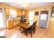Bright kitchen with wooden cabinets, dining table, and view of the back door at 3777 Edward Rd, Rex, GA 30273