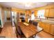 Eat-in kitchen with stainless steel appliances, wooden cabinetry, and a dining table at 3777 Edward Rd, Rex, GA 30273
