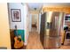 Kitchen area with stainless steel refrigerator, cabinets, and an adjacent hallway at 3777 Edward Rd, Rex, GA 30273