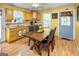 Bright eat-in kitchen featuring wood cabinets, granite countertops, and tiled backsplash, plus laminate flooring at 3777 Edward Rd, Rex, GA 30273