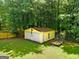 Exterior shot of a two-car storage shed featuring a separate service door and trailer at 3777 Edward Rd, Rex, GA 30273