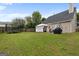 Backyard featuring a covered patio, seating area, grill, trampoline, and grass lawn at 1871 Sandy Trail Dr, Hampton, GA 30228