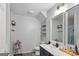 Bathroom with a vanity, mirror, open shelving, and plants at 1871 Sandy Trail Dr, Hampton, GA 30228