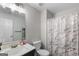 Bright bathroom featuring modern fixtures, vanity with mirror, and shower with decorative curtain at 1871 Sandy Trail Dr, Hampton, GA 30228