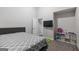 Bedroom with carpet, grey headboard, and a gray and white patterned quilt at 1871 Sandy Trail Dr, Hampton, GA 30228