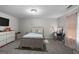 Cozy bedroom with a full size bed, carpet floors, a dresser, and vanity table with lighted mirror at 1871 Sandy Trail Dr, Hampton, GA 30228