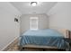 Bedroom featuring a window with blinds and a bed with a blue cover at 1871 Sandy Trail Dr, Hampton, GA 30228