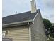 Home exterior showcasing new roof, vinyl siding, gutters, and chimney on a sunny day at 1871 Sandy Trail Dr, Hampton, GA 30228