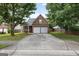 Charming brick home with a well-maintained lawn and a two-car garage at 1871 Sandy Trail Dr, Hampton, GA 30228