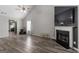 Bright living room featuring wood floors, a fireplace, and a ceiling fan at 1871 Sandy Trail Dr, Hampton, GA 30228
