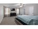 Bright main bedroom with carpet, tv, ceiling fan, and a dresser at 1871 Sandy Trail Dr, Hampton, GA 30228