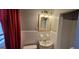 Neat bathroom featuring tiled walls, a vanity with a mirror, and a toilet at 1254 Ne Woodland Rd, Conyers, GA 30012