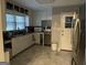 Well-lit kitchen featuring granite countertops, white cabinets, and stainless steel appliances at 1254 Ne Woodland Rd, Conyers, GA 30012