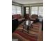 Relaxing sunroom featuring comfortable seating, a glass table, and a view of the outdoors at 1254 Ne Woodland Rd, Conyers, GA 30012