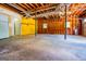 Unfinished basement, exposed joists, concrete floor, and a window at 133 Deerfield Ln, Carrollton, GA 30116