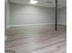 Finished basement with neutral paint, base trim, and wood-look floors at 133 Deerfield Ln, Carrollton, GA 30116