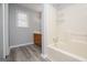 Bathroom featuring a tub shower, wood vanity, and wood-look floors at 133 Deerfield Ln, Carrollton, GA 30116