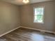 Bedroom features wood-look flooring and a bright window at 133 Deerfield Ln, Carrollton, GA 30116