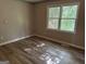 Bedroom features wood-look flooring and natural light at 133 Deerfield Ln, Carrollton, GA 30116