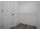 Walk-in closet with white walls, shelving, and grey floors at 133 Deerfield Ln, Carrollton, GA 30116