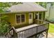 Wooden deck features stairs, wood railing and green siding at 133 Deerfield Ln, Carrollton, GA 30116