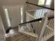View of a home entryway from the staircase looking down to a well-lit front door at 133 Deerfield Ln, Carrollton, GA 30116