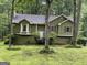 Charming green home featuring a well-maintained yard and a welcoming white front door at 133 Deerfield Ln, Carrollton, GA 30116