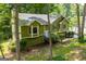 Charming green split-level home surrounded by mature trees at 133 Deerfield Ln, Carrollton, GA 30116